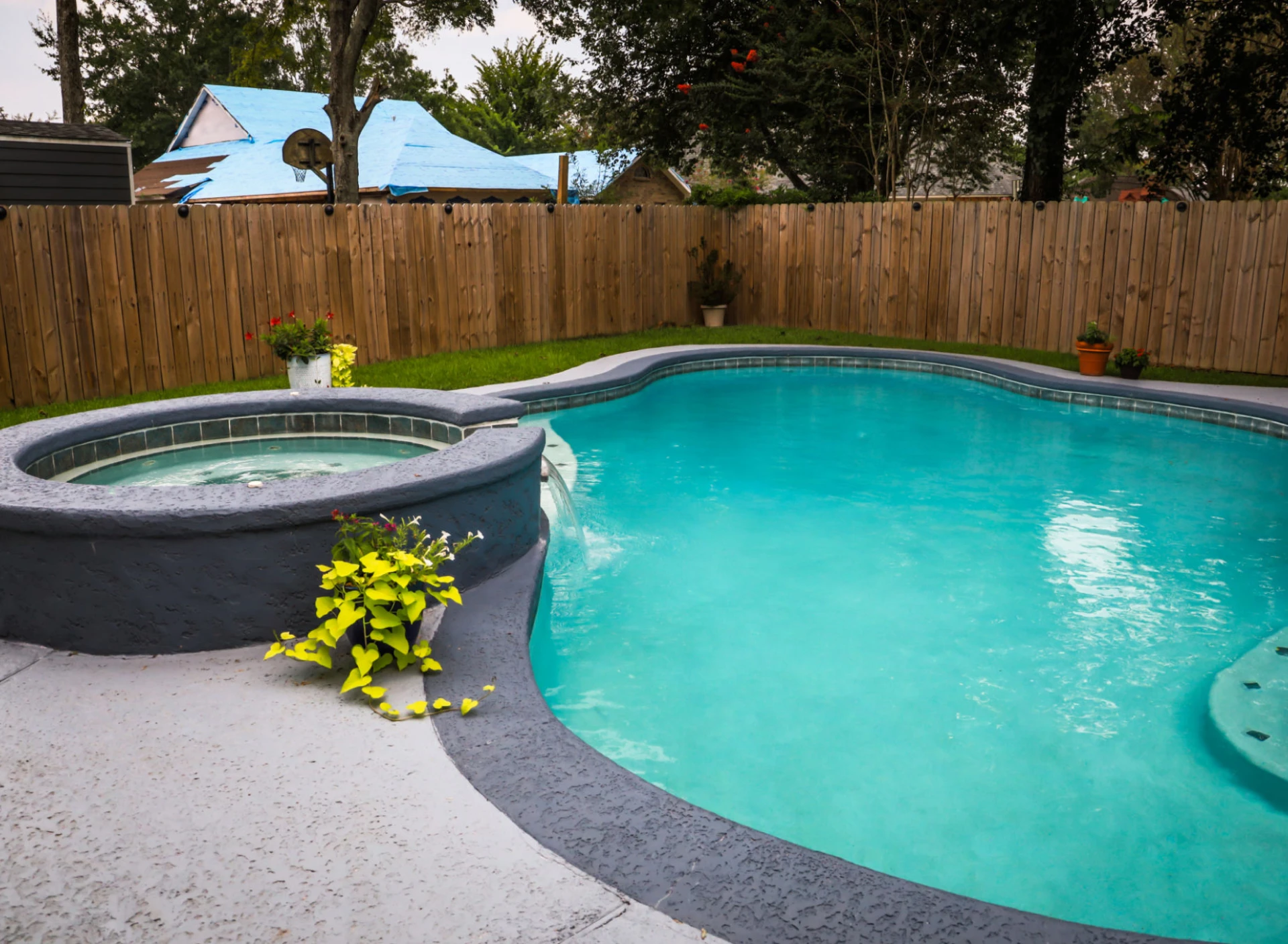 Backyard pool with hot tub
